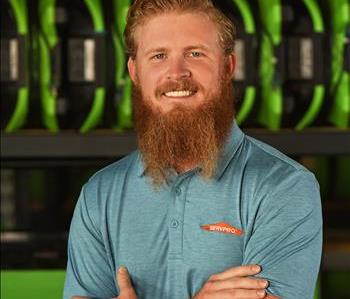 SERVPRO employee in blue polo posing for crew photo.