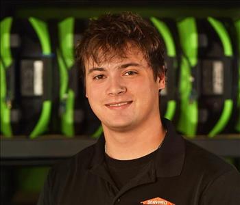 SERVPRO employee in black polo posing for crew photo.