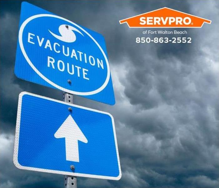 An evacuation route sign points the ways to safety.